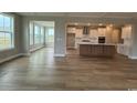 Open floor plan featuring a spacious living room, modern kitchen, and stunning hardwood floors at 4019 Bucolic Loop, Myrtle Beach, SC 29588