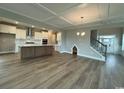 Open floor plan featuring a spacious living room, modern kitchen, and stunning hardwood floors at 4019 Bucolic Loop, Myrtle Beach, SC 29588