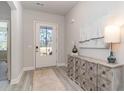 Bright entryway with a glass door, rustic console table, and light wood-look flooring at 418 Clear Lake Dr., Conway, SC 29526