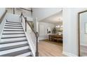 Bright entryway with hardwood floors, a staircase with white railings, and a view of the dining area at 419 Clear Lake Dr., Conway, SC 29526