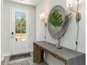 Stylish foyer featuring a console table, decorative mirror, and modern lighting at 426 Clear Lake Dr., Conway, SC 29526