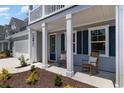 Inviting covered front porch with rocking chairs and manicured landscaping at 426 Clear Lake Dr., Conway, SC 29526