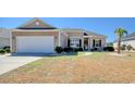 Lovely one-story home with a two-car garage, neat landscaping, and a welcoming front entrance at 434 Carrick Loop, Longs, SC 29568