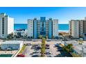 Scenic view of a multi-story condo building with a parking lot and ocean view, showcasing the coastal lifestyle at 4619 S Ocean Blvd. # 501, North Myrtle Beach, SC 29582