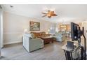 Open-concept living room featuring hardwood floors, a ceiling fan, and access to the kitchen at 4889 Magnolia Pointe Ln. # 105, Myrtle Beach, SC 29577