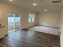 Open-concept living room features wood-look flooring, neutral paint, carpet, and a sliding glass door to the backyard at 536 Tillage Ct., Conway, SC 29526