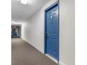 Hallway view of condominium door with carpeted floors and textured walls at 5905 South Kings Hwy. # 6215D, Myrtle Beach, SC 29575