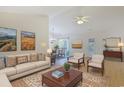 Open living room with neutral walls, wood floors, light-colored furniture, and view into dining area at 6413 Sapling Ct., Myrtle Beach, SC 29588