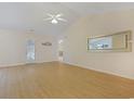 Expansive living room with wood flooring, ceiling fan, and view to back patio at 6413 Sapling Ct., Myrtle Beach, SC 29588