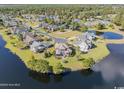 Beautiful aerial view of a waterfront home with stunning lake and neighborhood views at 6575 Sw Longwater Ct., Ocean Isle Beach, NC 28469