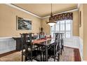 Formal dining room with classic decor, chandelier, and ample natural light at 6575 Sw Longwater Ct., Ocean Isle Beach, NC 28469