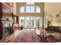 Elegant living room with fireplace, large windows, hardwood floors, and stylish decor at 6575 Sw Longwater Ct., Ocean Isle Beach, NC 28469