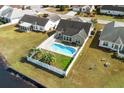 Aerial view of a private backyard featuring in-ground pool, patio area, and fenced yard with mature landscaping at 658 Pamlico Ct., Myrtle Beach, SC 29588