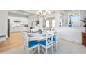 Bright dining room with a white table, seating for eight, and an open view to the kitchen at 7624 Azure Dr., Myrtle Beach, SC 29572