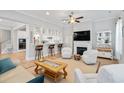 Inviting living room with fireplace, bar seating area, hardwood floors, and bright, neutral decor at 7624 Azure Dr., Myrtle Beach, SC 29572