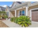 Inviting front porch with comfortable seating and lush plants, perfect for enjoying the outdoors at 802 46Th Ave. S, North Myrtle Beach, SC 29582