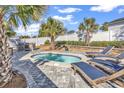 Relaxing backyard oasis featuring a private plunge pool, lounge chairs, and a built-in grill at 802 46Th Ave. S, North Myrtle Beach, SC 29582