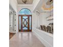 Grand foyer showcasing a decorative front door, tile flooring, and an open view to the dining room at 8068 Cortona Dr., Myrtle Beach, SC 29572