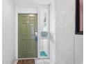 Exterior view of a condo door with door mat that says, 