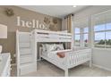 Cozy bedroom featuring a bunk bed with built-in storage and decor and a bright window showcasing the neighborhood at 973 Laconic Dr., Myrtle Beach, SC 29588