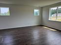 Spacious bedroom features hardwood floors and plentiful natural light from three windows at 1001 Cavaletti Ct., Myrtle Beach, SC 29588
