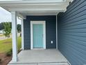 Close-up of the home's entry with a light blue front door and white trim at 1001 Cavaletti Ct., Myrtle Beach, SC 29588