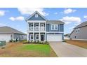 Charming two-story home boasts a double porch, attached garage and beautifully landscaped front yard at 1043 Harbison Circle, Myrtle Beach, SC 29579