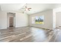 Sunlit bedroom featuring wood floors, neutral walls, and a large window overlooking the landscape at 1245 Cypress Shoal Dr., Conway, SC 29526