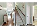 Hallway with a staircase and views into the living room and bathroom at 156 Parmelee Dr. # D, Murrells Inlet, SC 29576