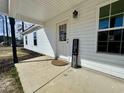 Close-up of front door with white siding and a 'Home Sweet Home' sign at 160 Leadwood St., Andrews, SC 29510