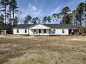 Inviting single-story home featuring a bright white exterior with black trim, a new roof and a gravel drive at 160 Leadwood St., Andrews, SC 29510
