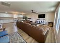 Open-concept living room featuring a large leather sofa, tv, and hardwood floors at 160 Leadwood St., Andrews, SC 29510