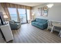 Bright living room with seating and ocean view at 2106 N Ocean Blvd. # 712, Myrtle Beach, SC 29577