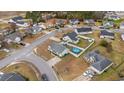 Aerial view of a neighborhood, highlighting a home with a fenced yard and pool at 2601 Rosehip Ct., Conway, SC 29527