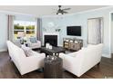 Bright living room featuring a fireplace, comfortable seating, and elegant decor at 2612 Watershed Way, Longs, SC 29568