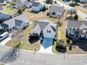 An aerial view of a home with a well-manicured lawn, shrubbery, a driveway, and an attached garage at 287 Whitchurch St., Murrells Inlet, SC 29576