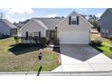 Inviting single-Gathering home with a well-kept lawn, tidy shrubbery, and an attached two-car garage at 287 Whitchurch St., Murrells Inlet, SC 29576