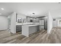Open kitchen with a center island, gray cabinetry, quartz countertops, and stainless appliances at 3807 Casey St., Loris, SC 29569