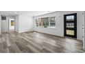 Bright living room featuring sleek vinyl plank flooring, neutral paint, and a large picture window at 3807 Casey St., Loris, SC 29569