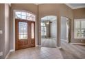 Grand foyer featuring a decorative front door, tile flooring, and arched openings to other rooms at 4245 Congressional Dr., Myrtle Beach, SC 29579