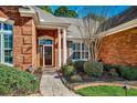 Inviting front entrance with stone walkway, brick facade, white columns, and well-maintained landscaping at 4245 Congressional Dr., Myrtle Beach, SC 29579