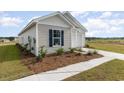 Well-maintained single-story home with fresh landscaping and a paved walkway leading to the entrance at 457 Acosta Circle, Conway, SC 29527
