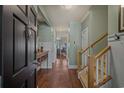 Inviting foyer with hardwood floors and staircase, creating a warm and welcoming entrance to the home at 48 Twelve Oaks Dr. # 3, Pawleys Island, SC 29585