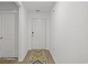 Hallway with sleek floors and neutral walls provides access to bedrooms and bathrooms at 519 Grass Fern Ct., Longs, SC 29568