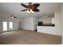 Open-concept living area with carpet flooring, french doors to the yard, and adjacent kitchen at 528 Banks Dr. # 2-4 & 2-4G, Myrtle Beach, SC 29588