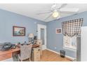 A well-lit office space with light blue walls, a ceiling fan and warm wood-look floors at 6001-1086 S Kings Hwy., Myrtle Beach, SC 29575
