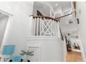 Elegant foyer with white staircase, decorative wood banister, and view into living area at 601 Gloucester Terrace Circle # 3C, Myrtle Beach, SC 29572