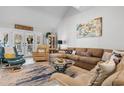 Bright living room with vaulted ceilings, comfortable seating, and view to porch with 'Beach House' sign at 601 Gloucester Terrace Circle # 3C, Myrtle Beach, SC 29572