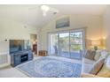 Inviting living room featuring a sliding glass door to a balcony and cozy furnishings at 670 Riverwalk Dr. # 304, Myrtle Beach, SC 29579