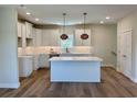 Newly built kitchen with shaker cabinets, a spacious island, stainless appliances, and modern pendant lights at 713 9Th Ave. S, North Myrtle Beach, SC 29582